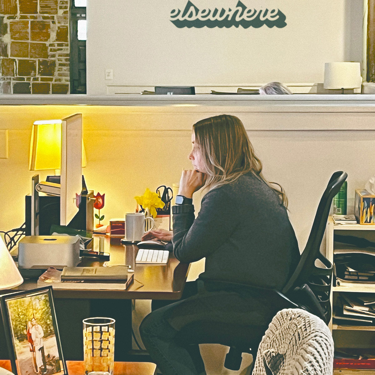 Alice sitting at desk in deep thought