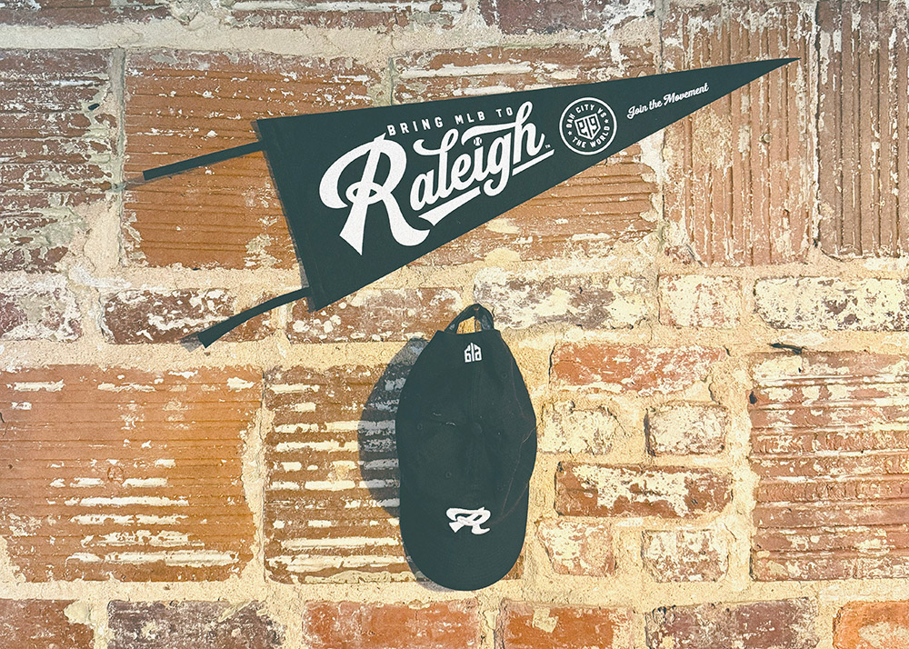 Banner and ball cap hanging on a brick wall
